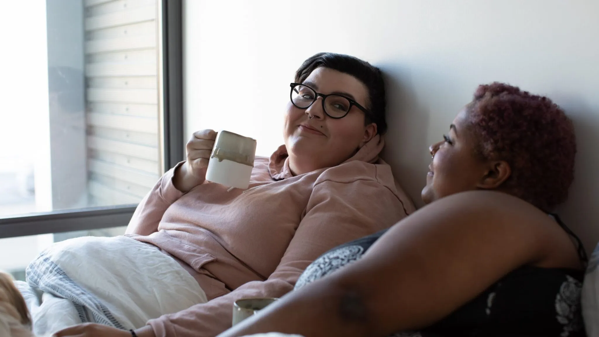 A married couple relaxes after arriving in the US after their same sex marriage immigration process.